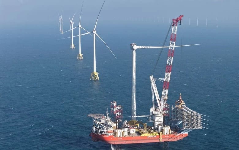 Workers install wind turbine blades at the Taiwan Greater Changhua 4 offshore wind farm.
