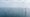 Offshore wind farm at sea with rows of large turbines