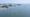 Aerial view of an offshore wind farm among the islands off Sinan, South Jeolla, with monopile foundations and a service vessel