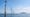 Illustrative image: Offshore wind farm at sea on a clear day, with distant islands