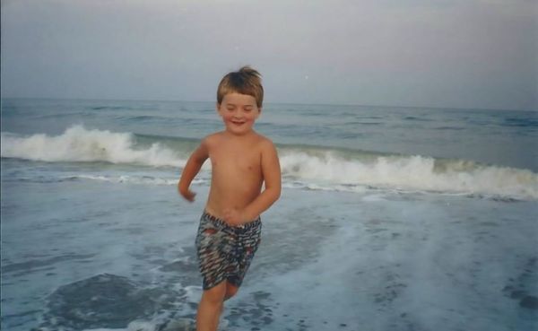 A child playing in the waves.