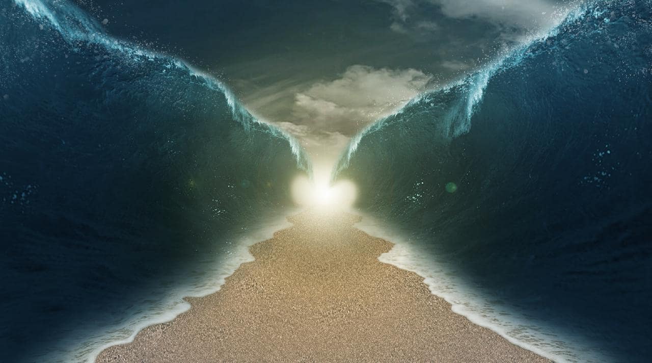 Path split through the river with walls of water on both sides.