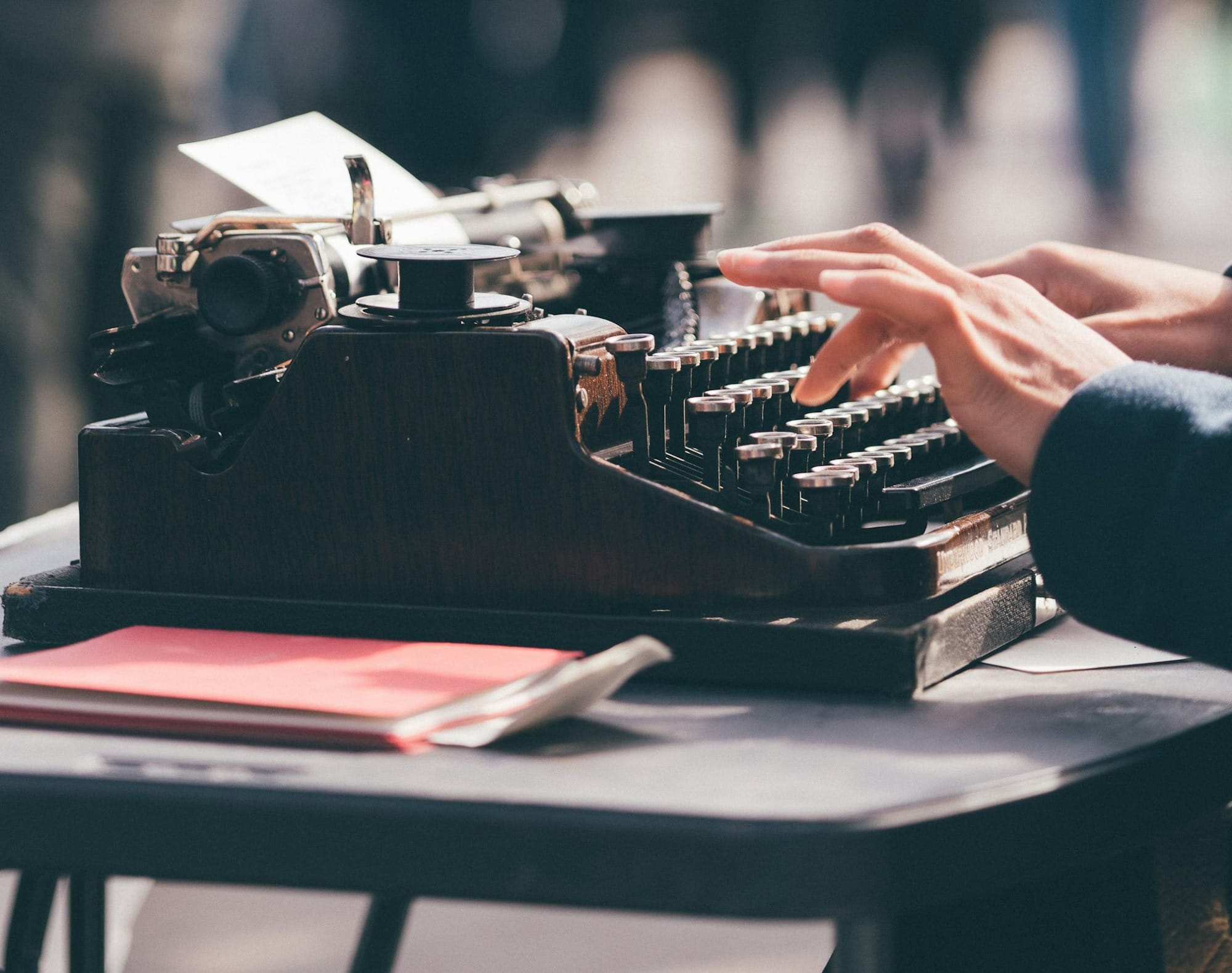 person using black typewriter