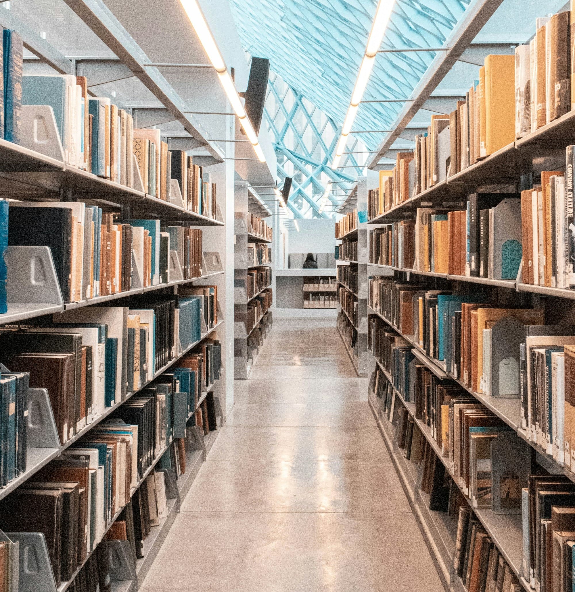 brown wooden book shelves in library