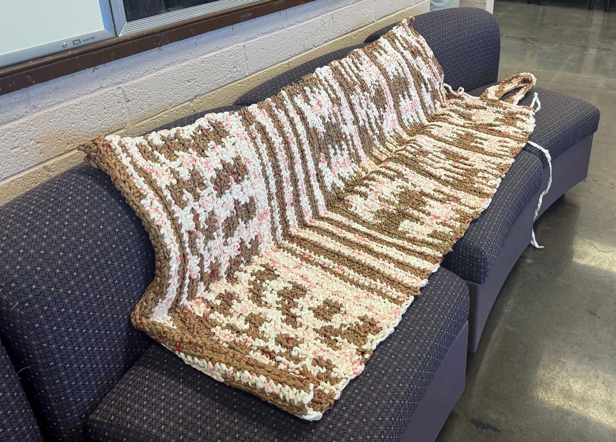 Archer Center volunteers repurpose bags into sleeping mats