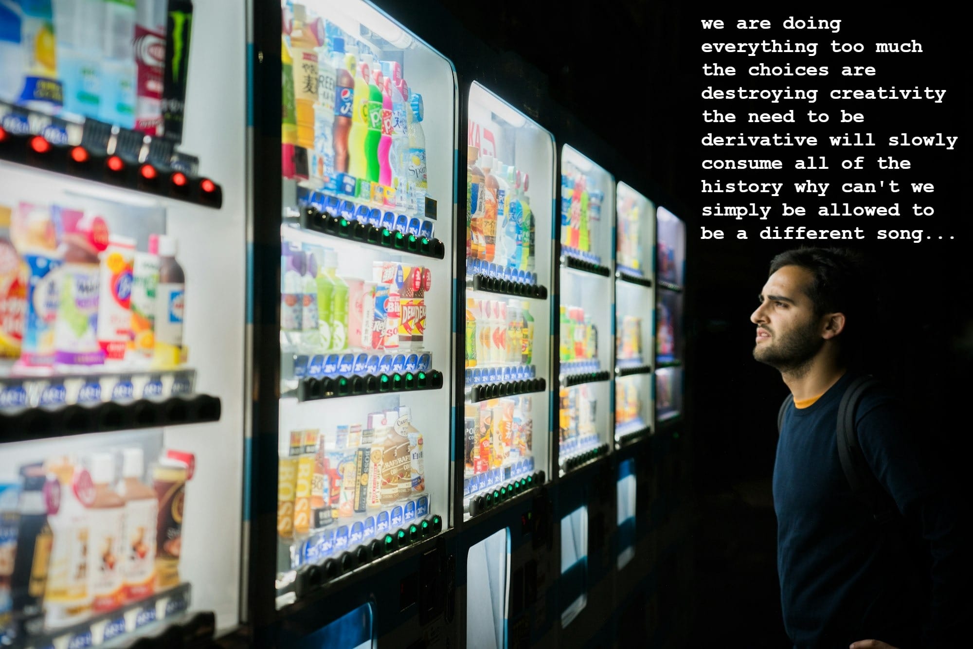 man on front of vending machines at nighttime