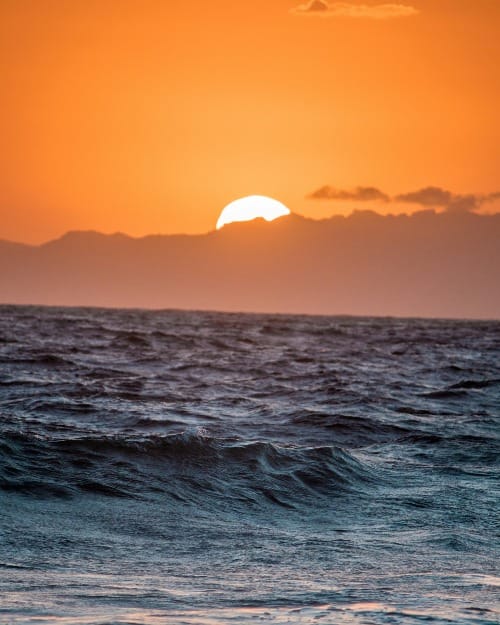 body of water during sunset