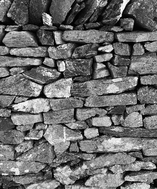 a black and white photo of a stone wall