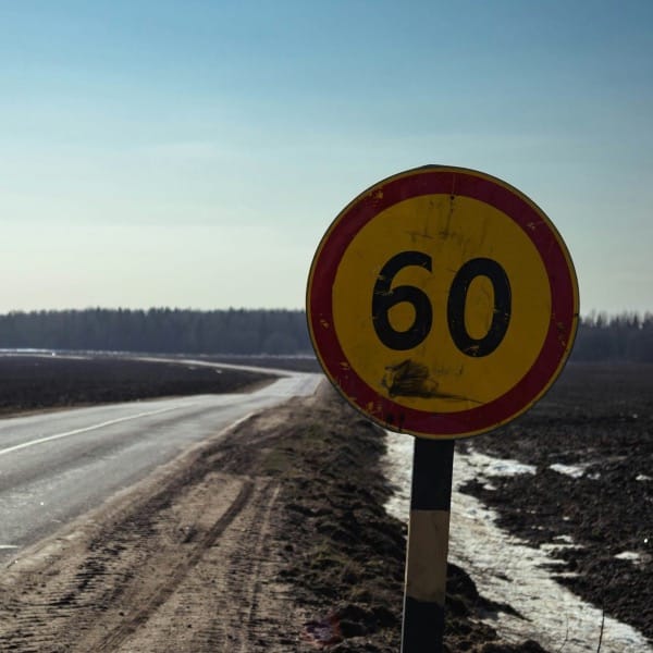 Road sign shows 60 with a rural landscape