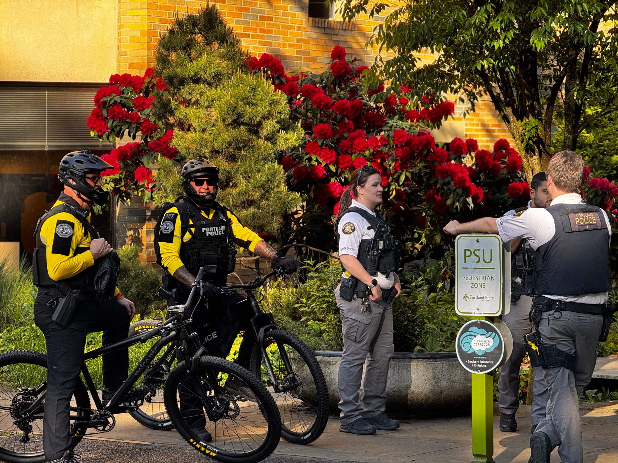 A few RRT bike cops and police liaison officers chatting on campus at 6:04pm