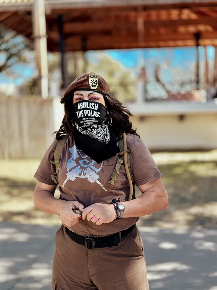 Carnalismo National Brown Berets wearing all brown, and a black bandana that says "Abolish the Police"