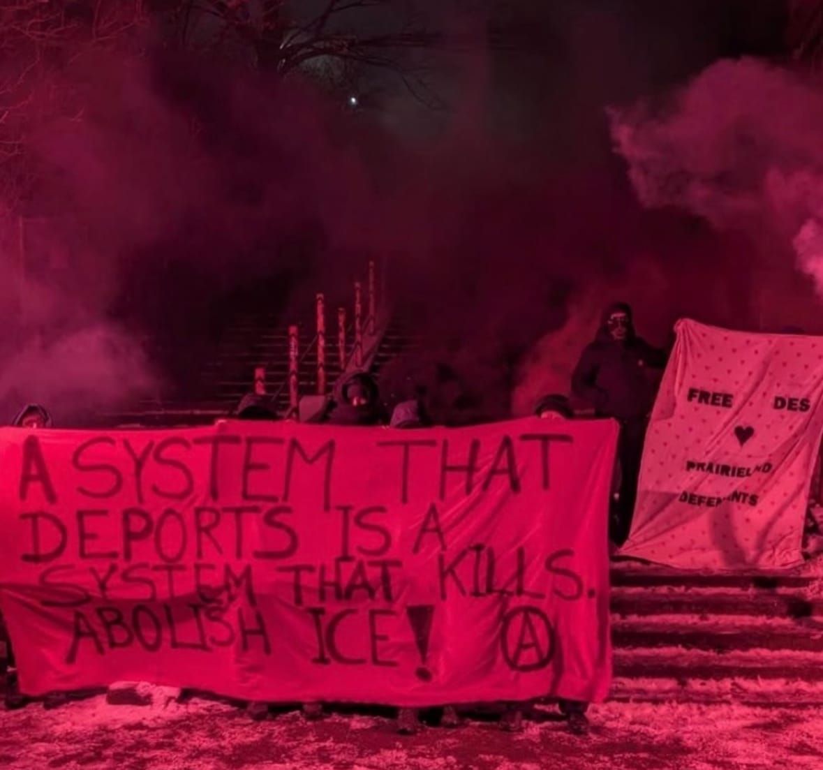 banner says: “a system that deports is a system that kills. Abolish ICE"