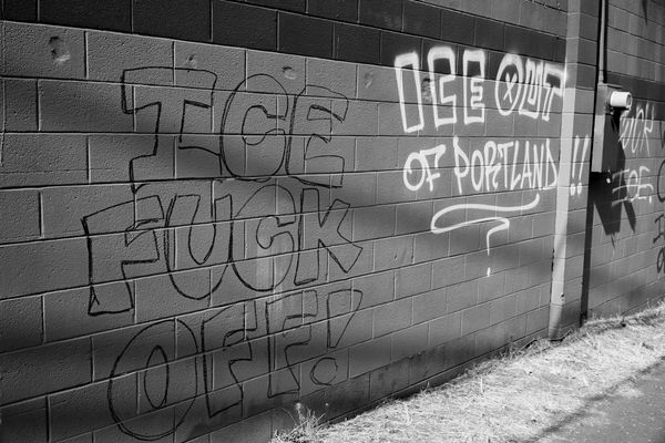 graffiti across from the ICE facility says “ICE fuck off!” and “ICE out of Portland!!"