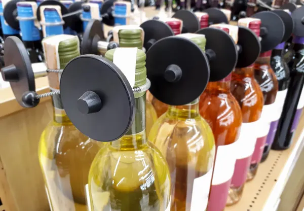 Security tags on bottles in a retail store