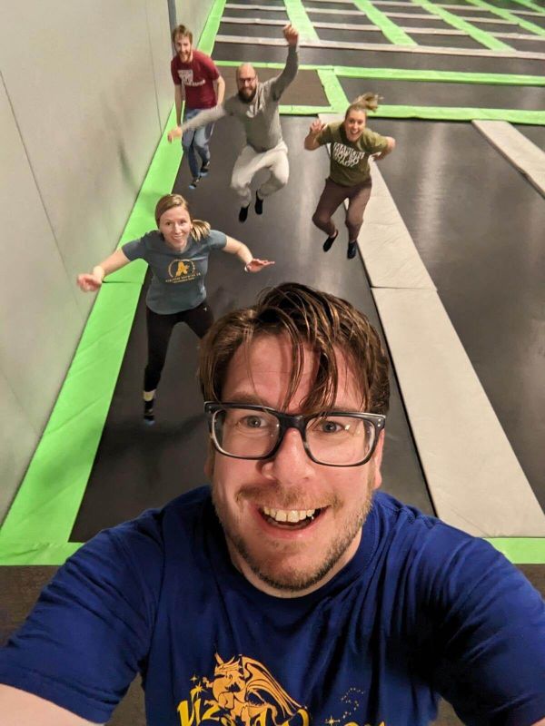 Several people at a trampoline park