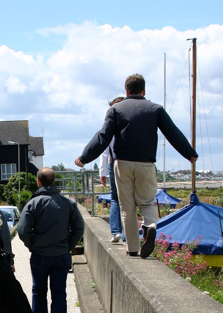 Piers Jones walking on a wall on a trip to Whitstable