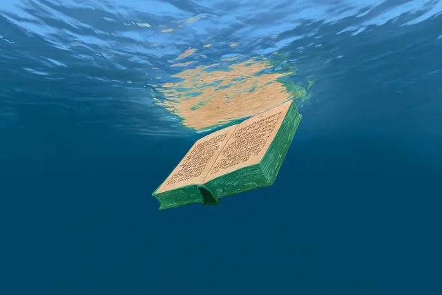 A sodden book sinks beneath the waves of the Cornish coast