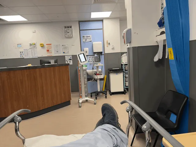 A man's legs and feet on a gurney in a hospital. 