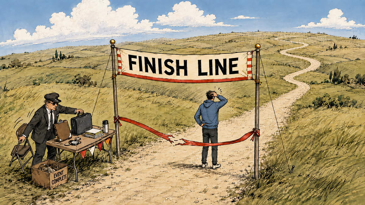 Person beyond a finish line on a winding road through rolling hills while an official packs up nearby.