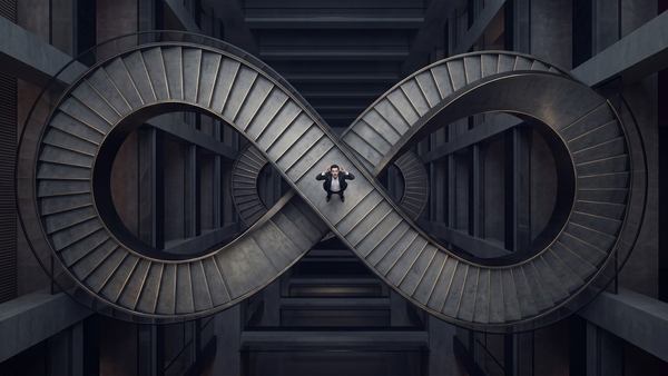 A person stands at the center of an infinity-shaped staircase, surrounded by dark architectural walls.