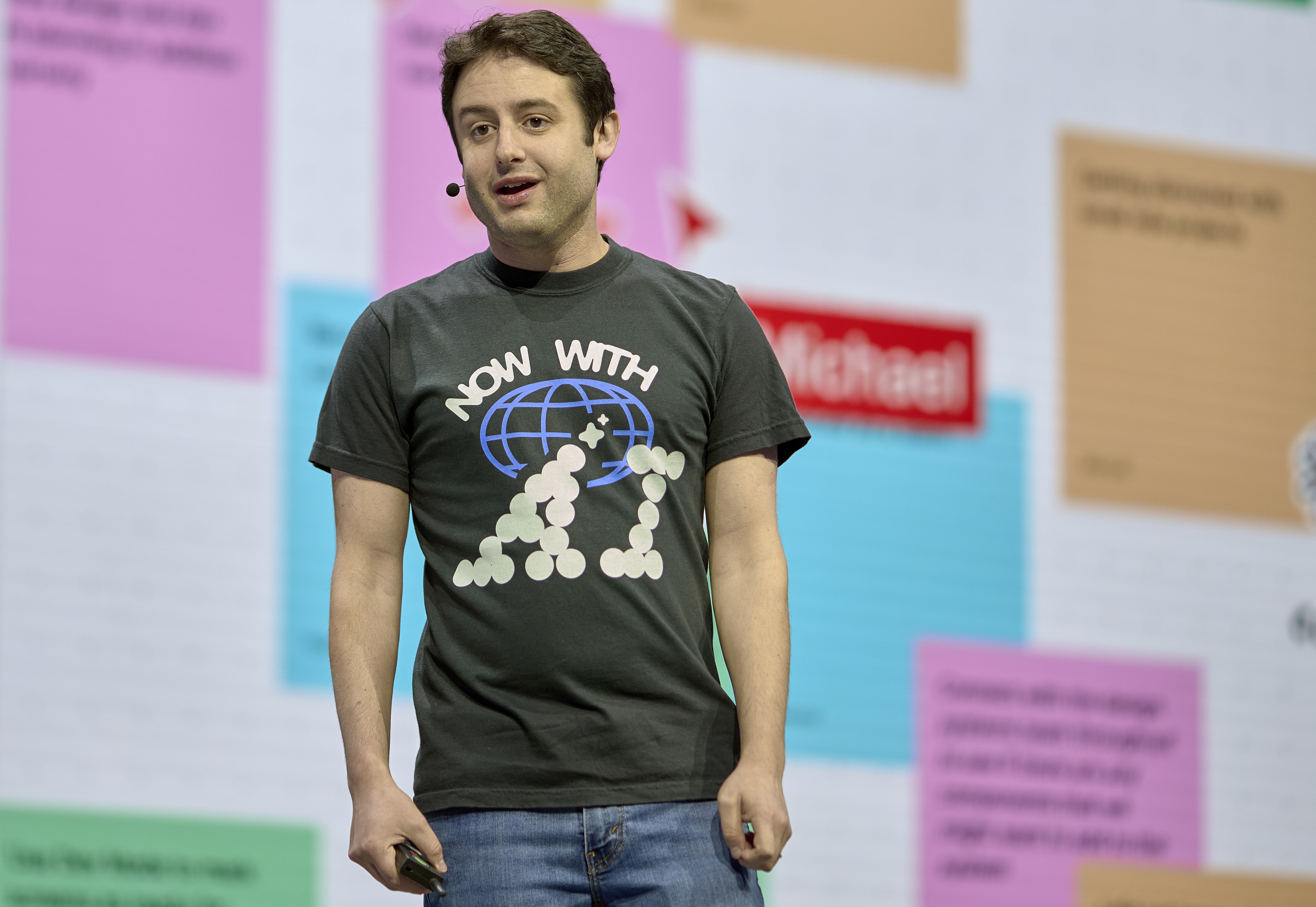 Figma CEO Dylan Field at Figma Config conference in 2024 wearing a 'Now with AI' t-shirt.