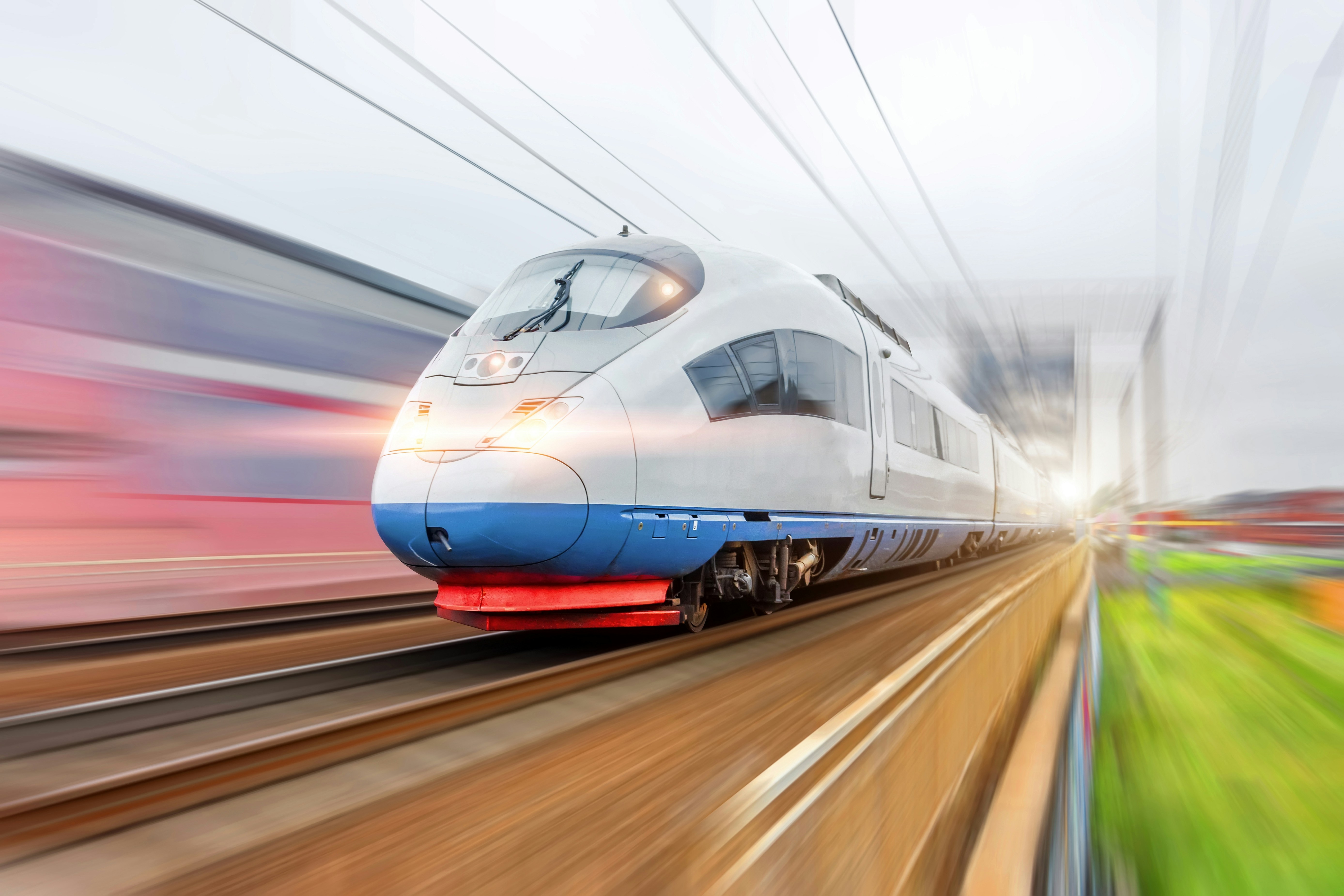 High-speed train racing down the tracks with motion blur, symbolizing acceleration, agility, and technological progress.