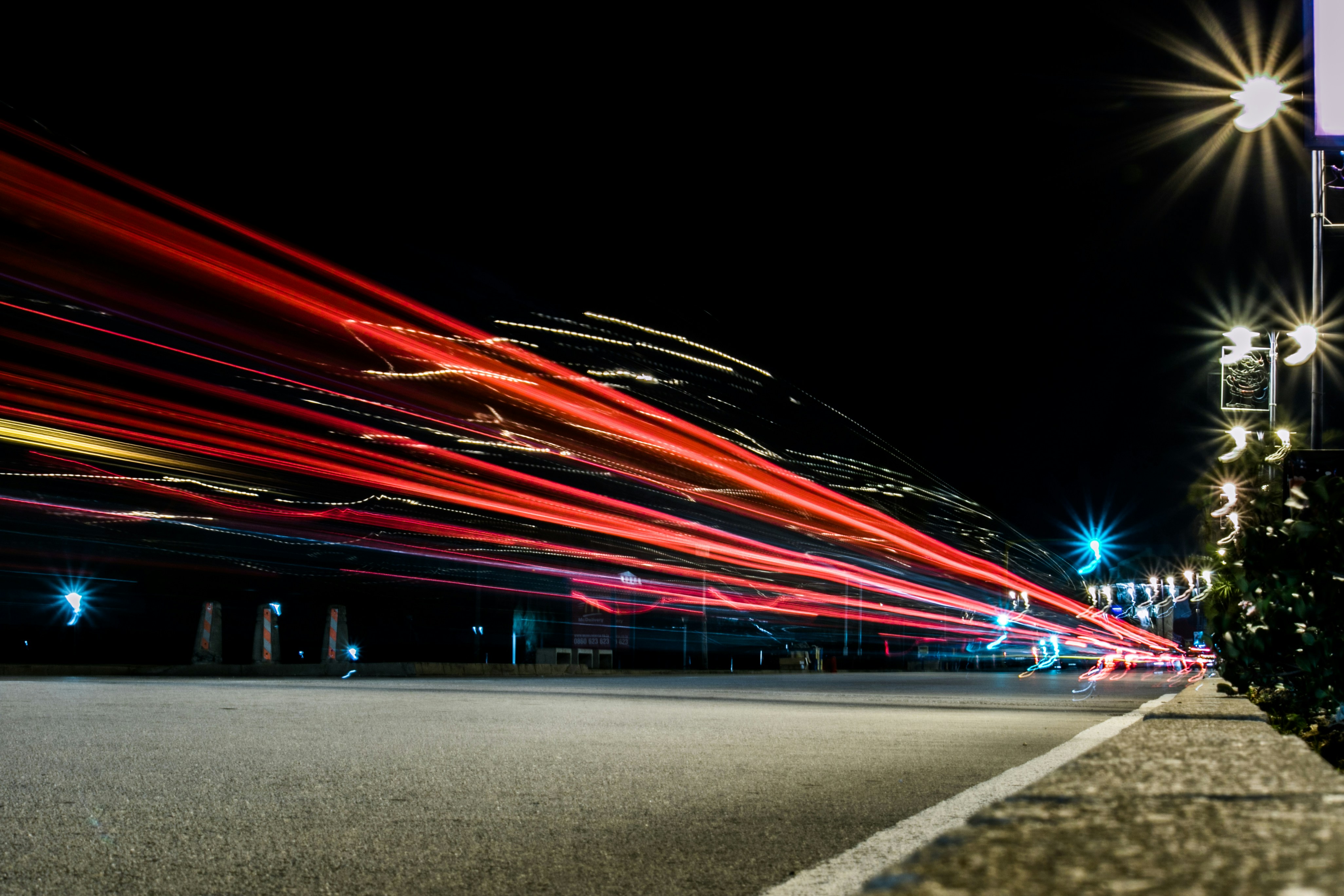 Time lapsed photo showing cars speeding through city.