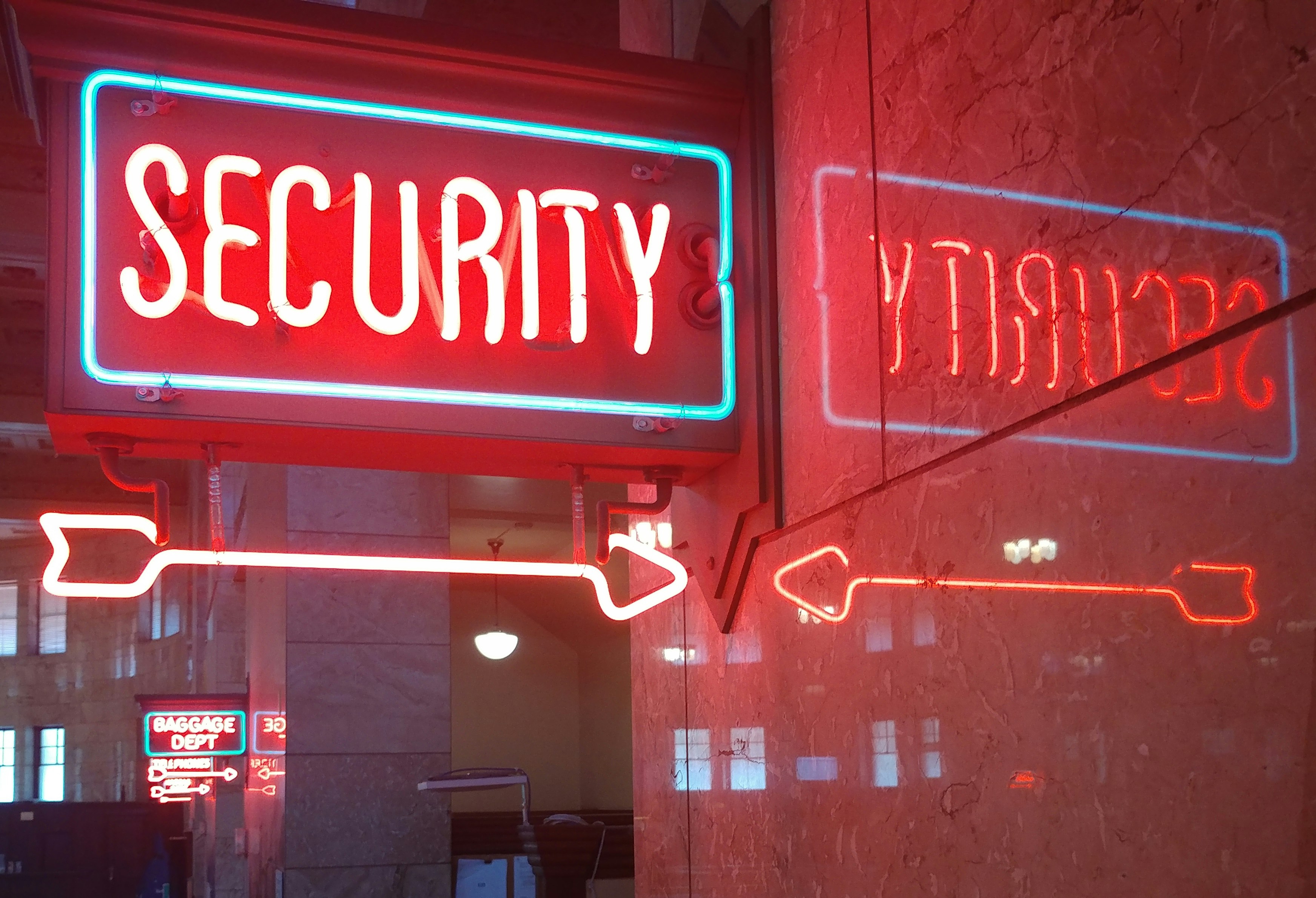 Pink neon security sign.
