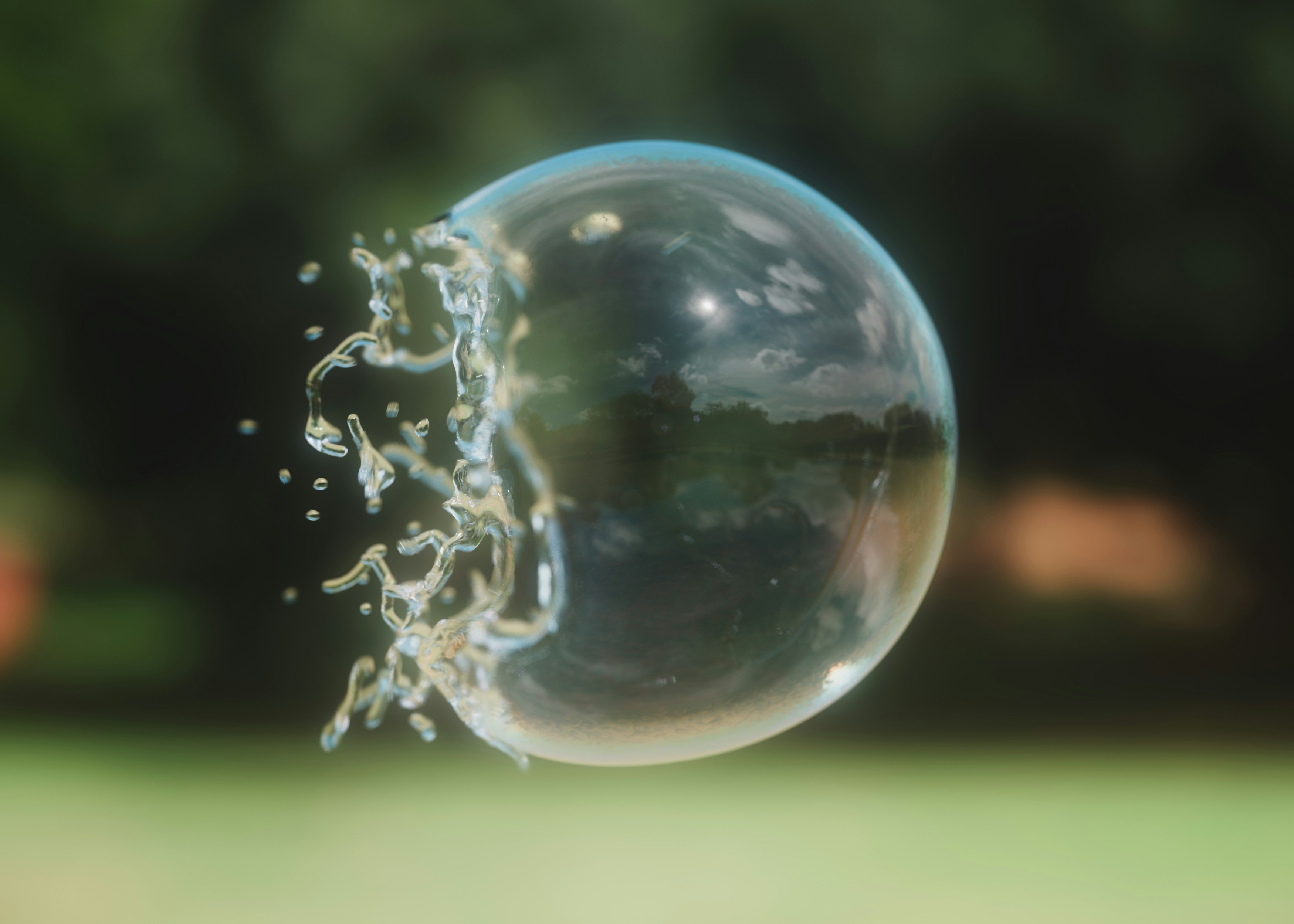 A close-up of a soap bubble mid-burst, with water droplets flying outward and a blurred green background behind it.