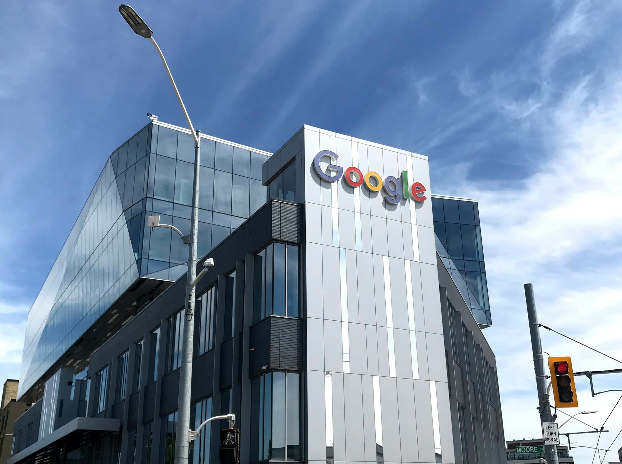 Modern glass building with Google logo on the side.