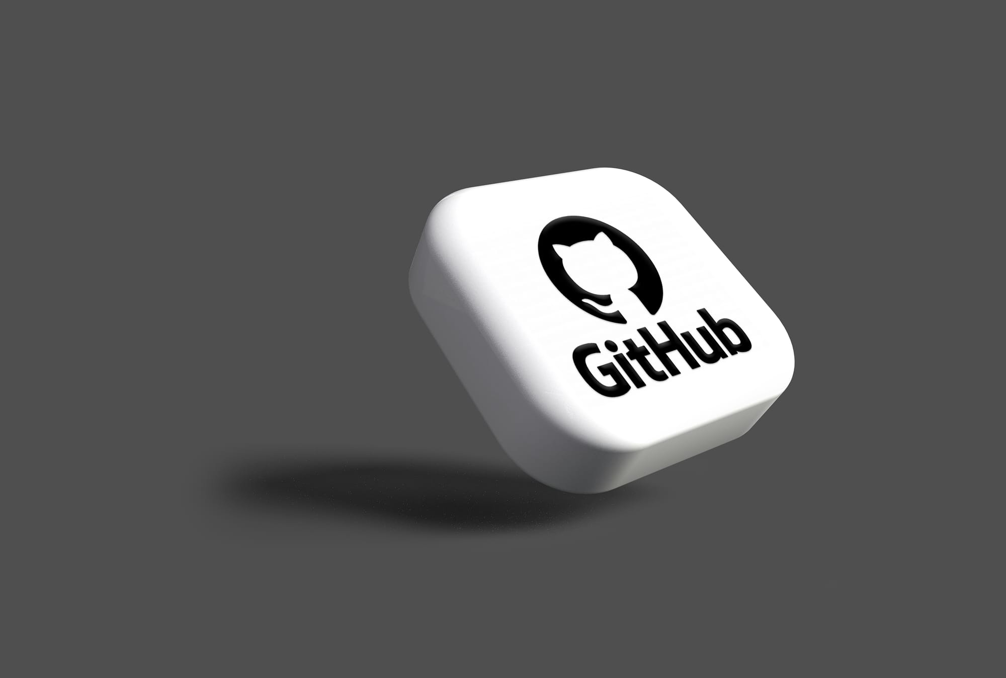 Floating 3D tile with GitHub logo icon on a gray background.