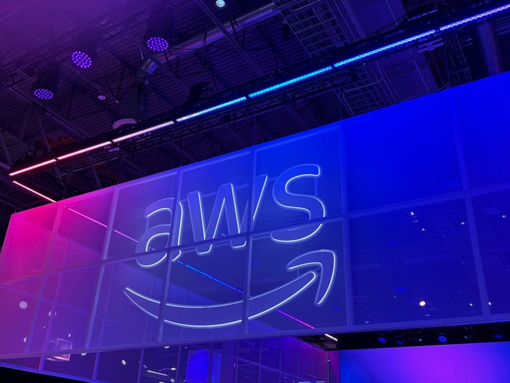 Purple and pink AWS logo on show floor at re:Invent 2025.