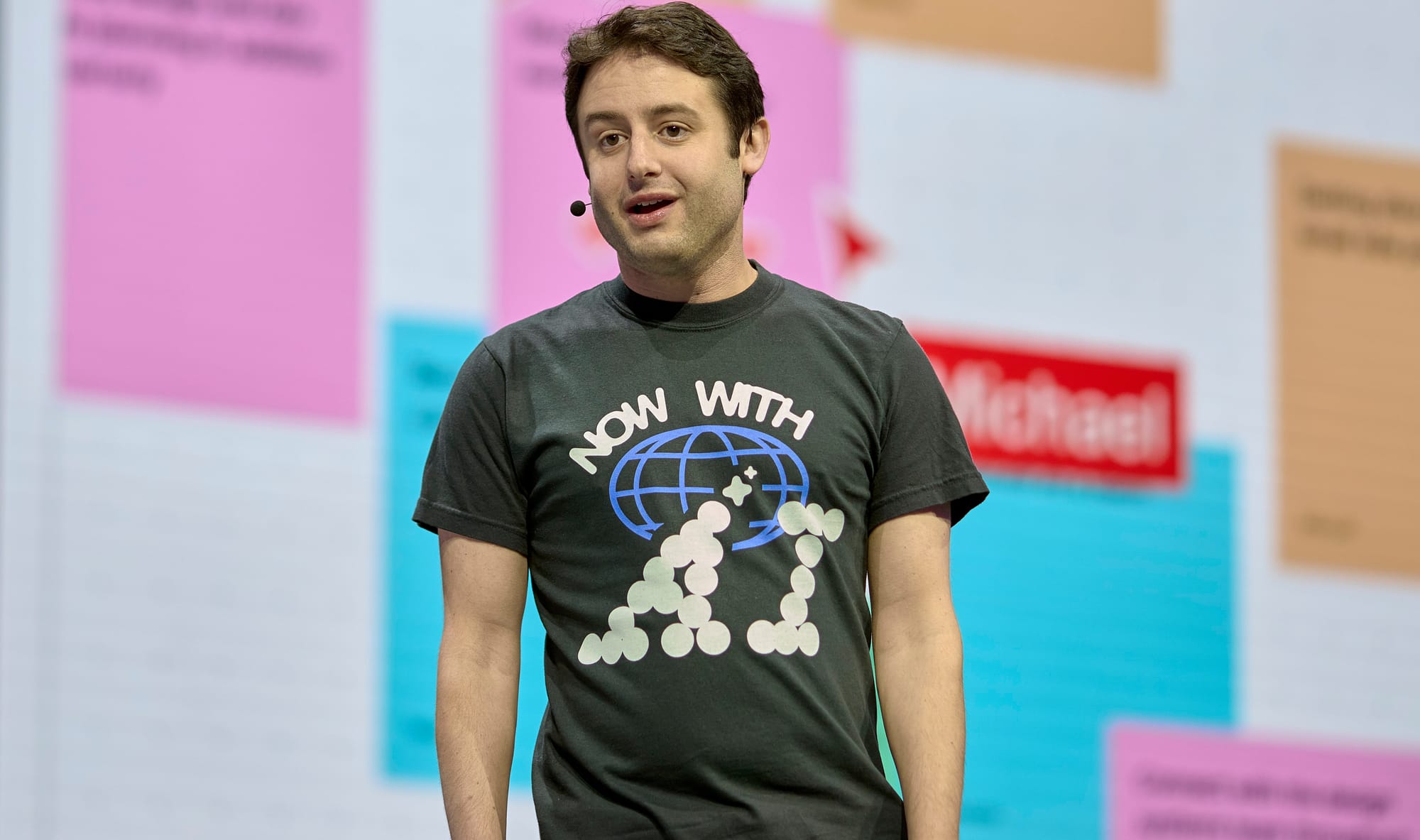 Figma CEO Dylan Field wearing a "Now with AI" tshirt.