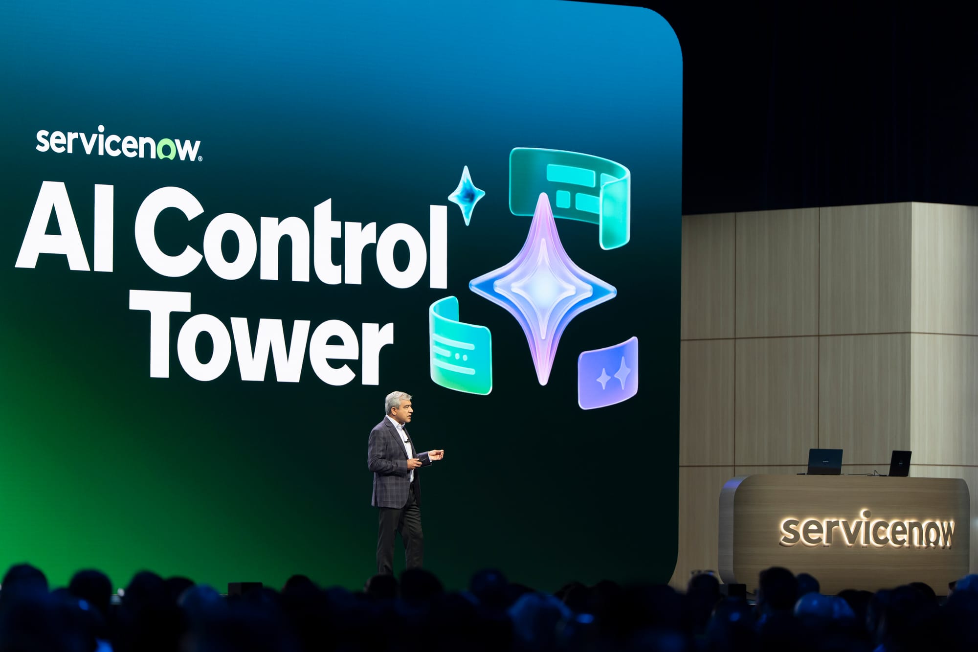 Amit Zavery presenting ServiceNow “AI Control Tower” on stage at a conference
