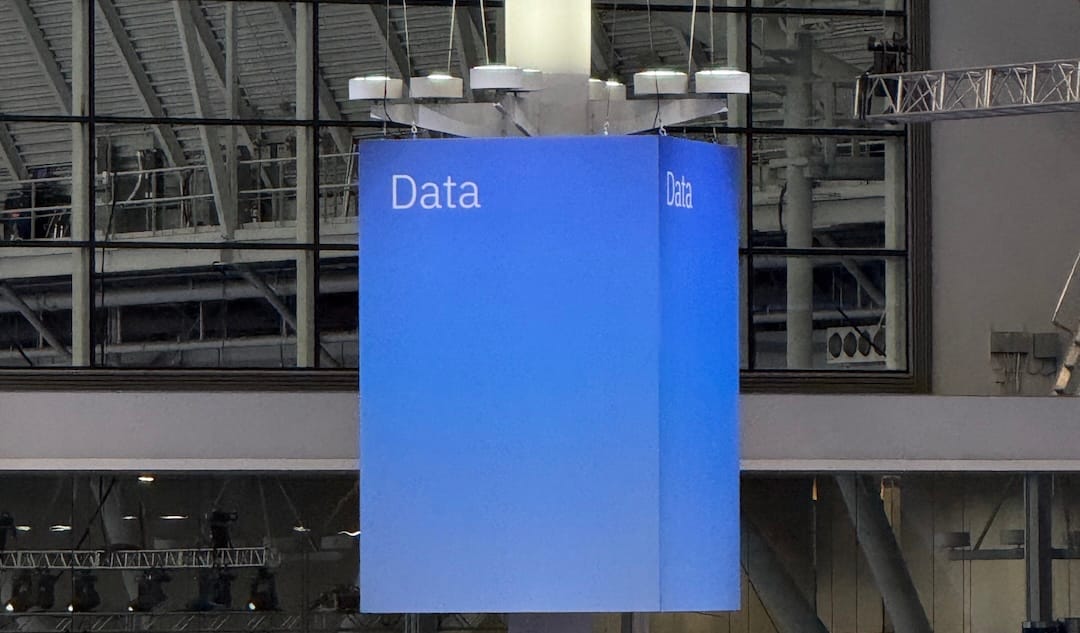 Blue sign with the word Data on it in white on pole in conference center.