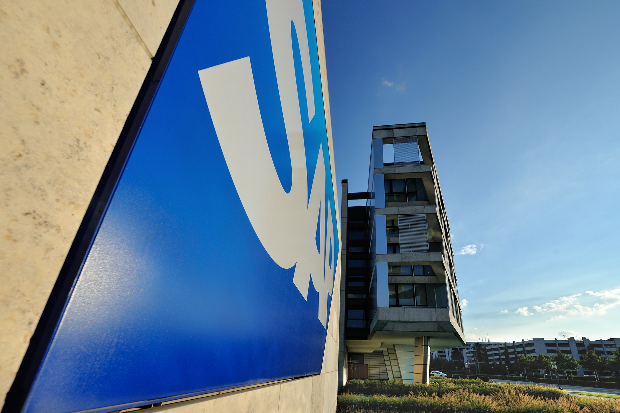 Large SAP logo sign beside a modern office building under a clear blue sky