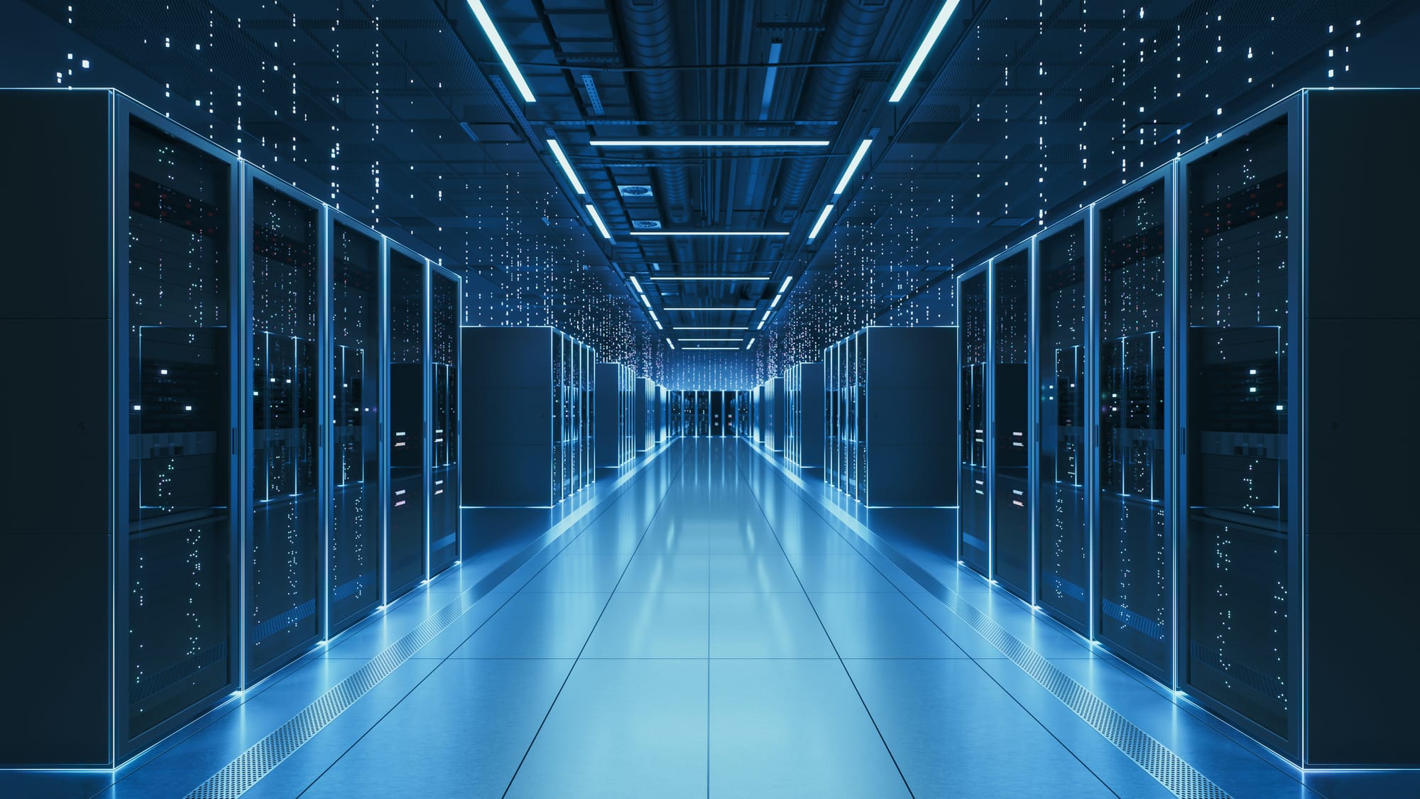 Rows of illuminated server racks inside a modern data center.