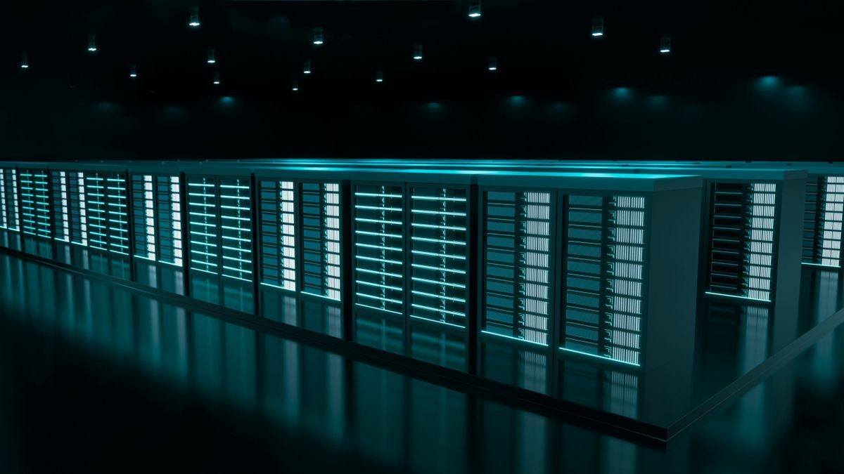 Rows of illuminated server racks in a dark, high-tech data center, glowing in teal light under ceiling spotlights.