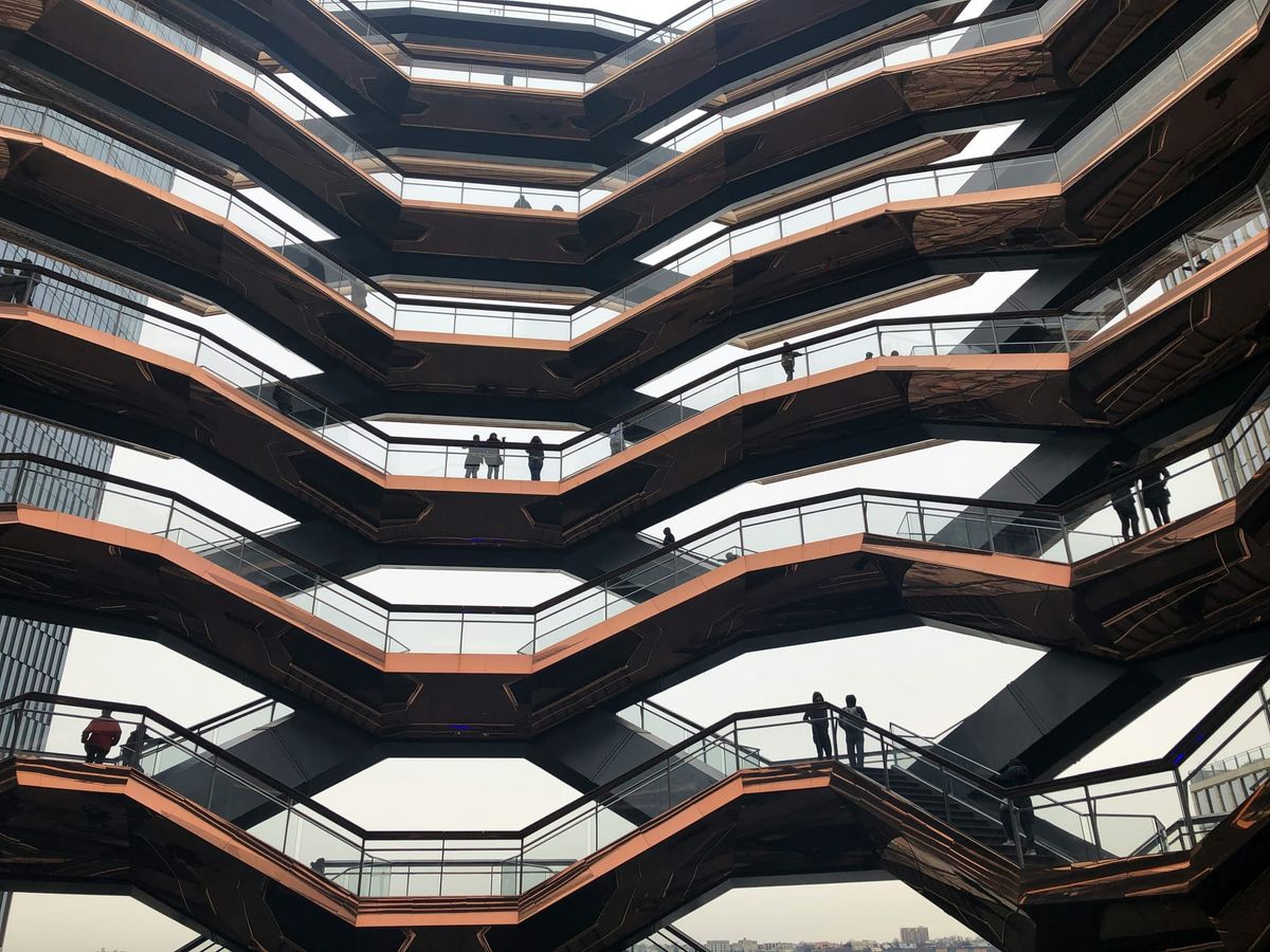 People stand on the interconnected staircases in New York City's Hudson Yards.