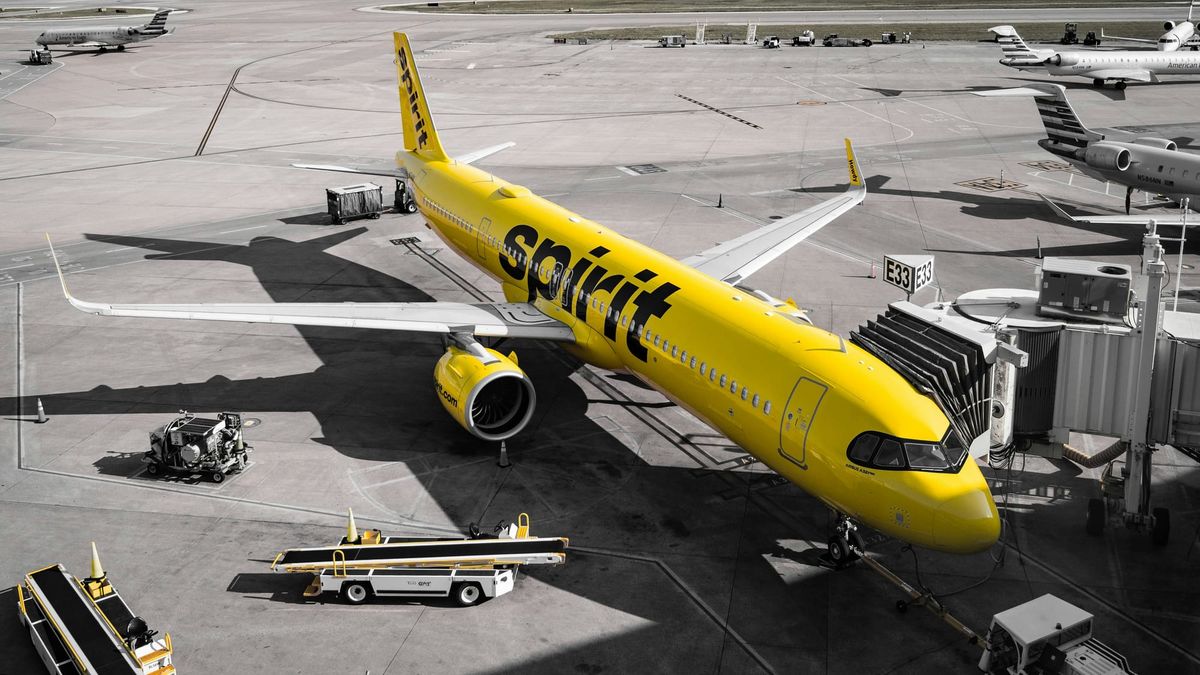 Spirit Airlines plane parked at an airport gate.