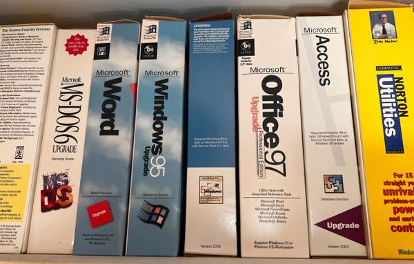 Boxed software on a shelft including MS-DOS 6, Windows 95, Office 97 and Norton Utilities