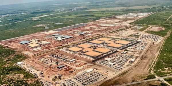 Aerial view of Crusoe Energy’s large-scale data center complex under construction in Abilene, Texas, showing multiple tan-roo