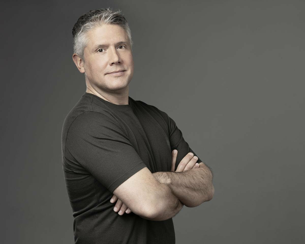 Darren Mowry, head of startups at Google Gloud standing with his arms folded.