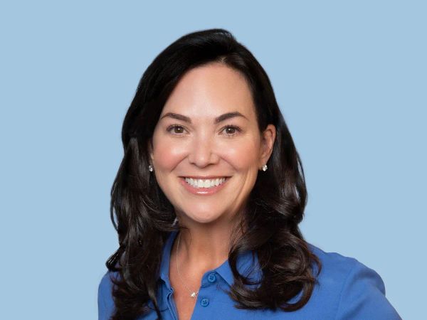 PagerDuty CEO Jennifer Tejada wearing a blue blouse standing against a light blue background. 