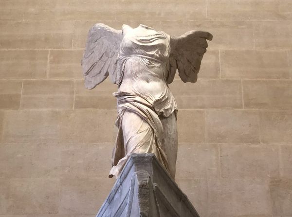 Headless winged marble statue.