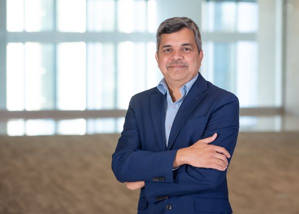 Photo of Milind Naphade, SVP of AI foundations at Capital One standing with his arms folded.