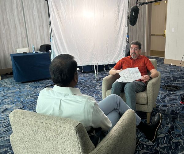 Video recording set with Swamy Kocherlakota being interviewed by Ron Miller from FastForward.