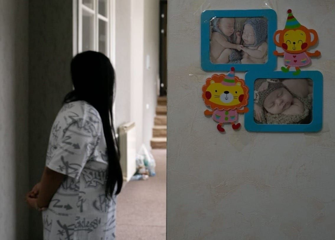 Photographs of newborn babies were the only decoration on the walls of the home were Nui* and several other surrogate mothers were housed. Photography credit: Pearly Jacob.