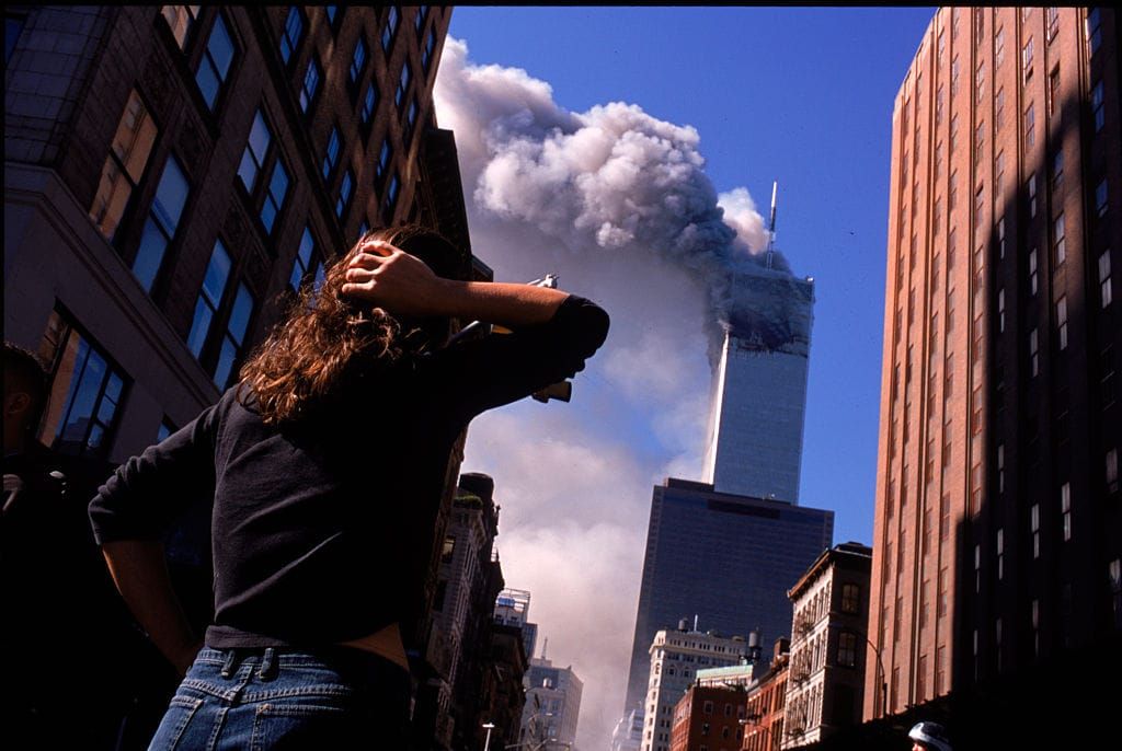 A photo of a woman watching the burning World Trade Center towers in New York on Sept. 11, 2021