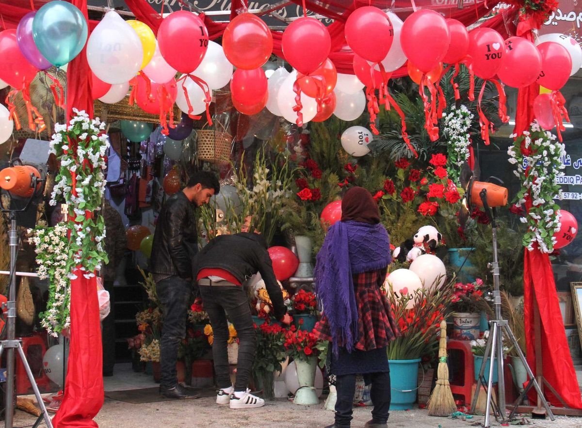 A photo of people looking at flowers